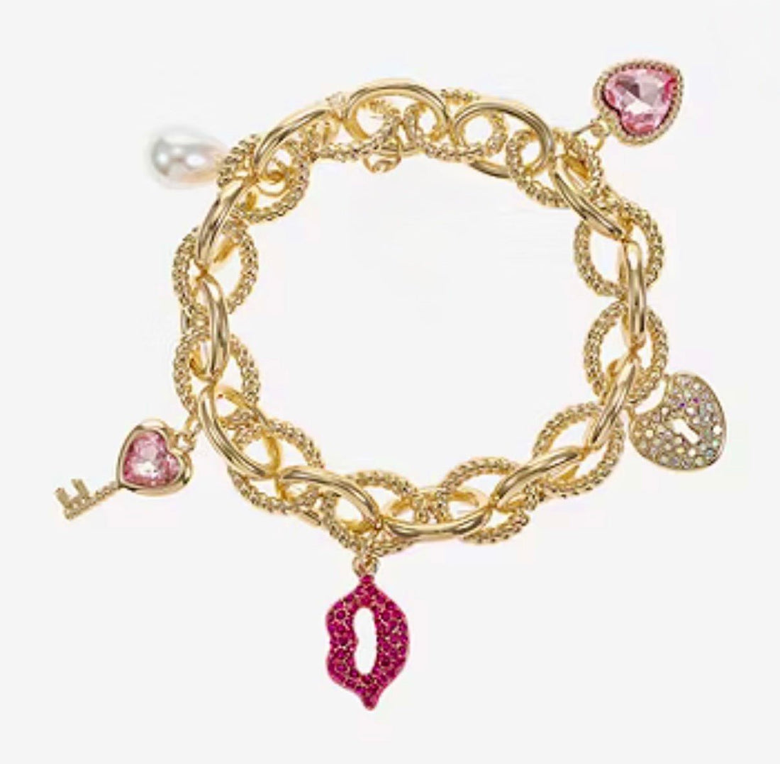 Gold Tone and Pink Charm Bracelet - Reed House of Jewels