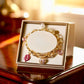 Gold Tone and Pink Charm Bracelet - Reed House of Jewels