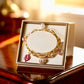 Gold Tone and Pink Charm Bracelet - Reed House of Jewels