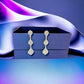 Gold Tone Grey Crystal Triple Drop Earrings - Reed House of Jewels