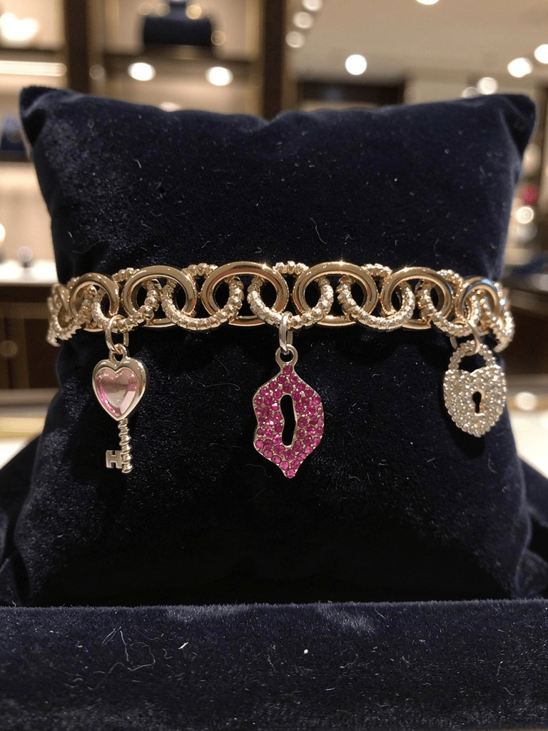 Gold Tone and Pink Charm Bracelet - Reed House of Jewels