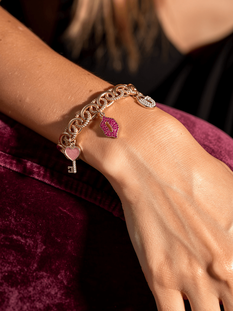 Gold Tone and Pink Charm Bracelet - Reed House of Jewels