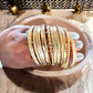 Gold Tone Textured Metal Bangle Stack - Reed House of Jewels