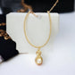 Gold Tone Wrapped Necklace with Gold and Faux Pearl Pendant - Reed House of Jewels